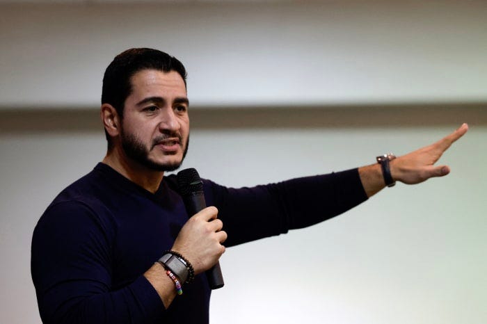 Abdul El-Sayed speaks with a microphone in hand and points toward the crowd Abdul El-Sayed speaks with a microphone in hand and points toward the crowd