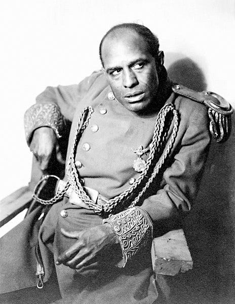 a black and white photo of a black man in a soldier's costume