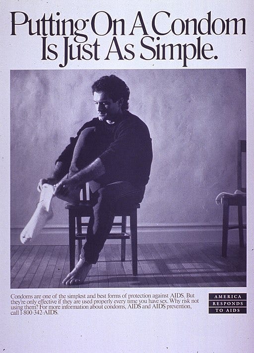 A man is sitting on a chair, putting on a sock. Text heading: “Putting on a condom is just as simple.”