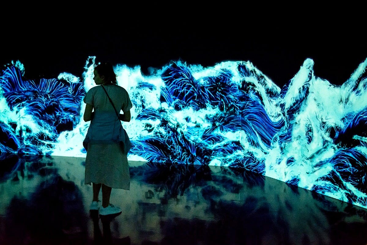 A visitor stands in a digital wave room at teamLab Borderless in Tokyo. Image: Domenico Convertini via Wikimedia Commons A visitor stands in a digital wave room at teamLab Borderless in Tokyo. Image: Domenico Convertini via Wikimedia Commons