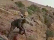 A horrific frame shows a soldier shooting at the body of a prisoner. A horrific frame shows a soldier shooting at the body of a prisoner.