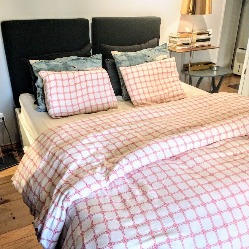 A duvet-covered bed in Lisbon.
