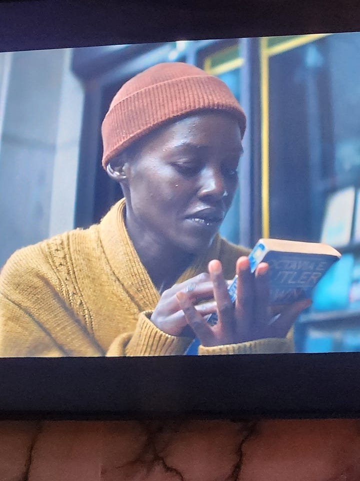 Lupita Nyong'o plays a character surviving an alien attack in NYC and holds Octavia Butler's alien science fiction novel Dawn in her hands.