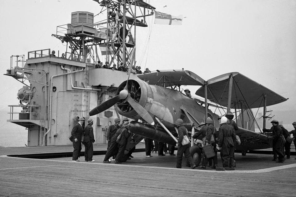 A Swordfish of No. 835 Squadron is lifted onto the flight deck of the escort carrier Battler for convoy escort duty in the North Atlantic on May 1, 1943. (Imperial War Museum A 16651) A Swordfish of No. 835 Squadron is lifted onto the flight deck of the escort carrier Battler for convoy escort duty in the North Atlantic on May 1, 1943. (Imperial War Museum A 16651)