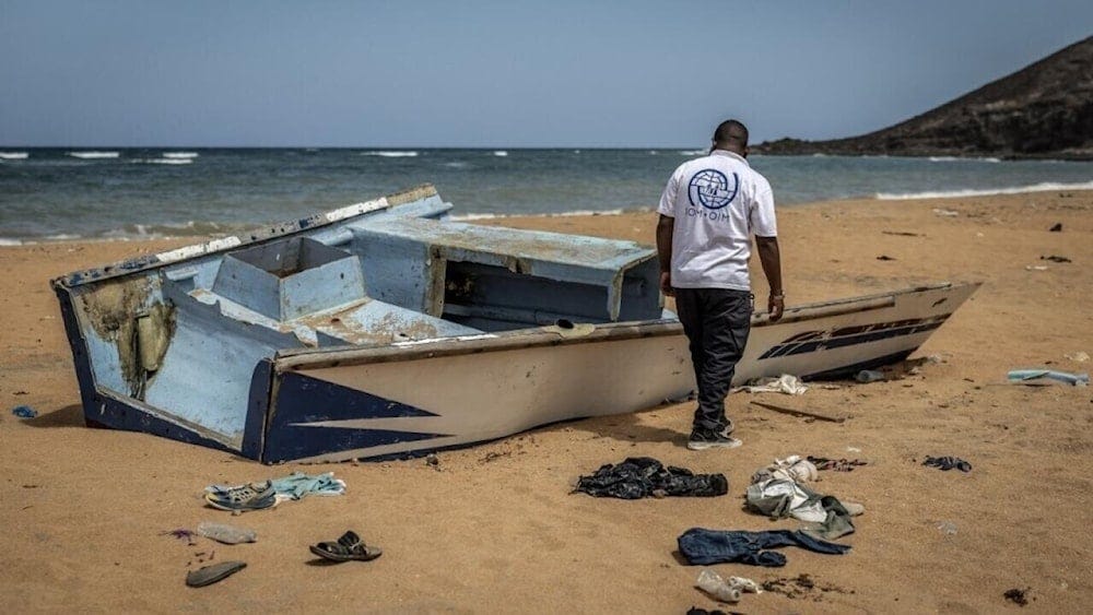 A member of the International Organization for Migration inspecting the abandoned wreckage of a boat that capsized while attempting to transport migrants to Yemen, near Obock, Djibouti, on April 12, 2026. (Luis Tato/AFP) A member of the International Organization for Migration inspecting the abandoned wreckage of a boat that capsized while attempting to transport migrants to Yemen, near Obock, Djibouti, on April 12, 2026. (Luis Tato/AFP)