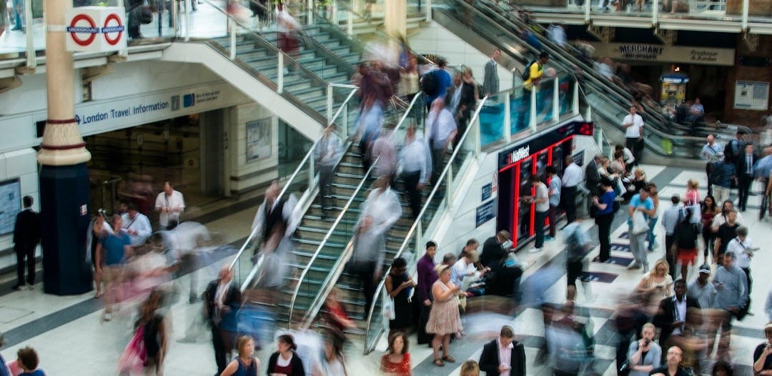 people standing and walking on stairs in mall