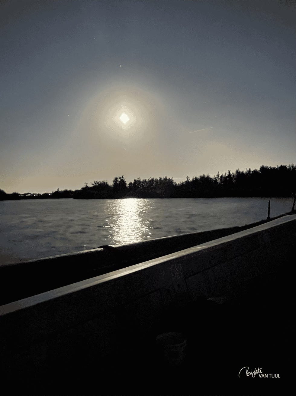 the moon reflecting in the lake