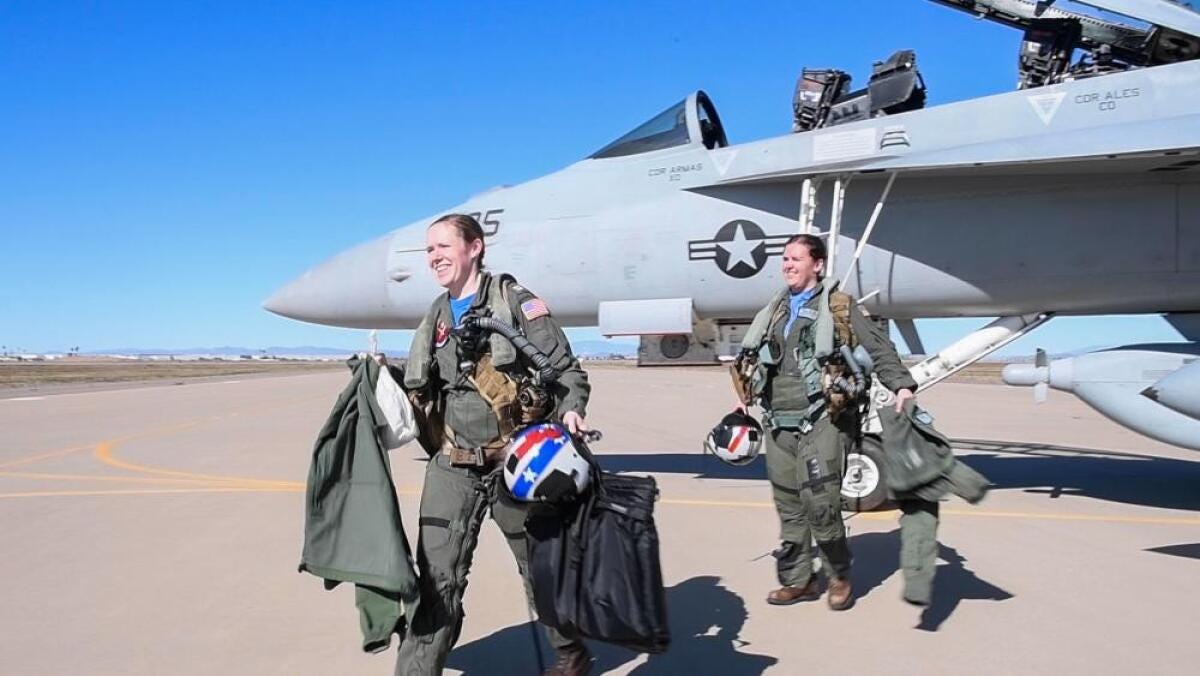 Two naval aviators walk away from their EA-18G Growler jet Two naval aviators walk away from their EA-18G Growler jet