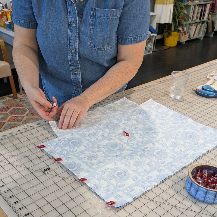 a person clipping a bag pattern together, a person sewing on a serger