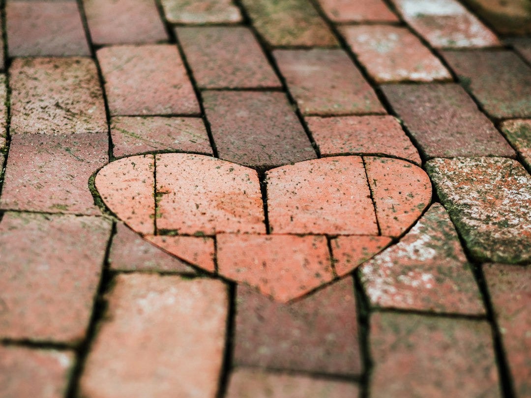 A brick pathway with a heart-shaped inlay