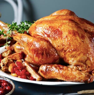 A roasted turkey on a platter

Description automatically generated