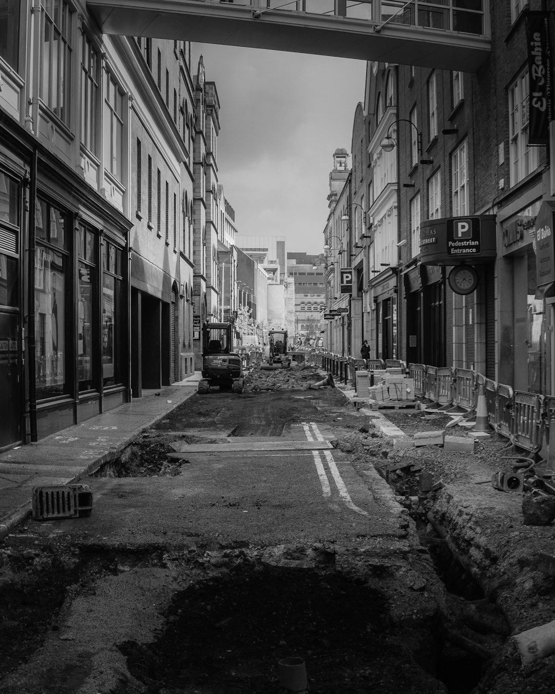empty street in between of buildings during daytime