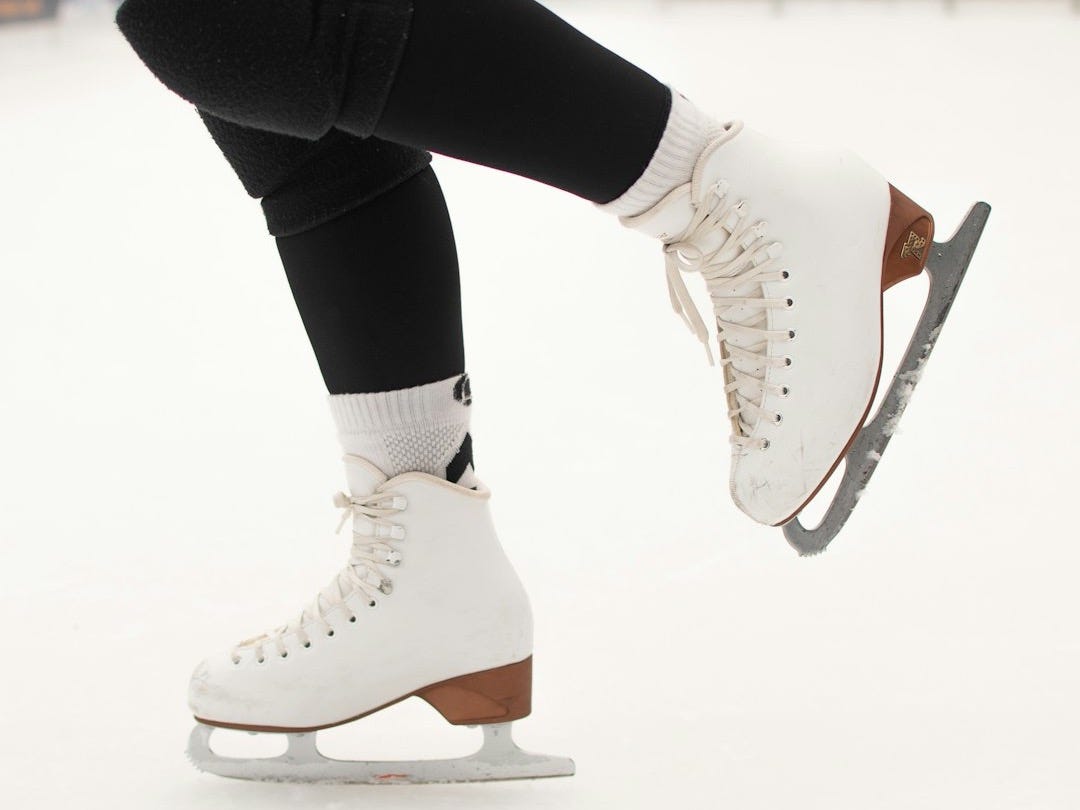 a person riding a skateboard on a snowy surface a person riding a skateboard on a snowy surface