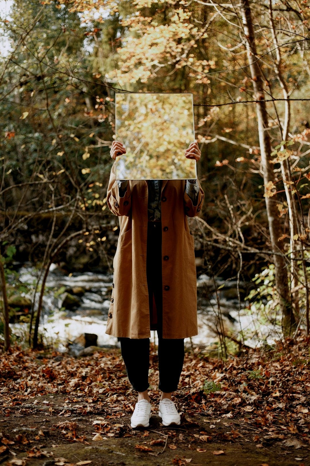woman in brown coat holding floral frame woman in brown coat holding floral frame