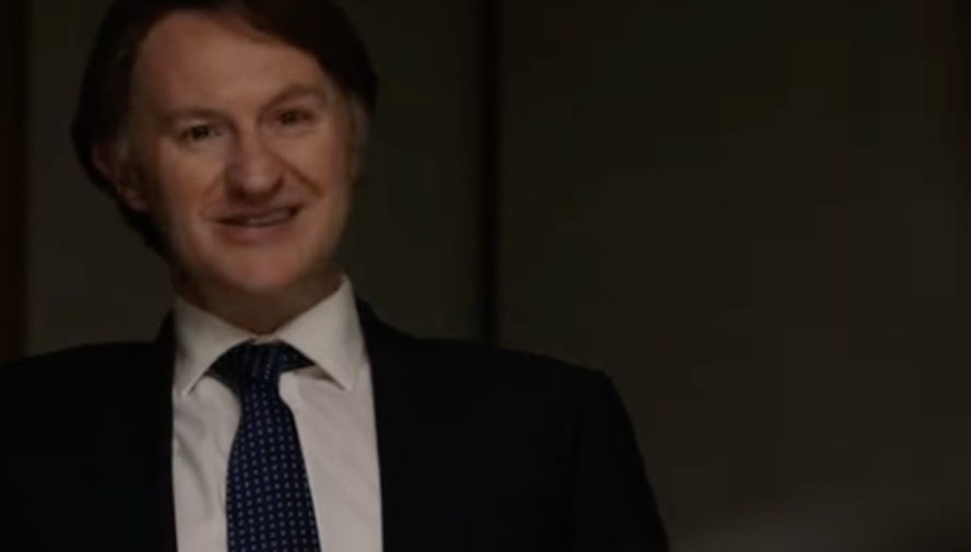 A person in a suit and tie

AI-generated content may be incorrect.