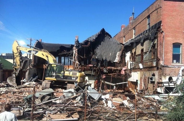 An old newspaper building is torn down.
