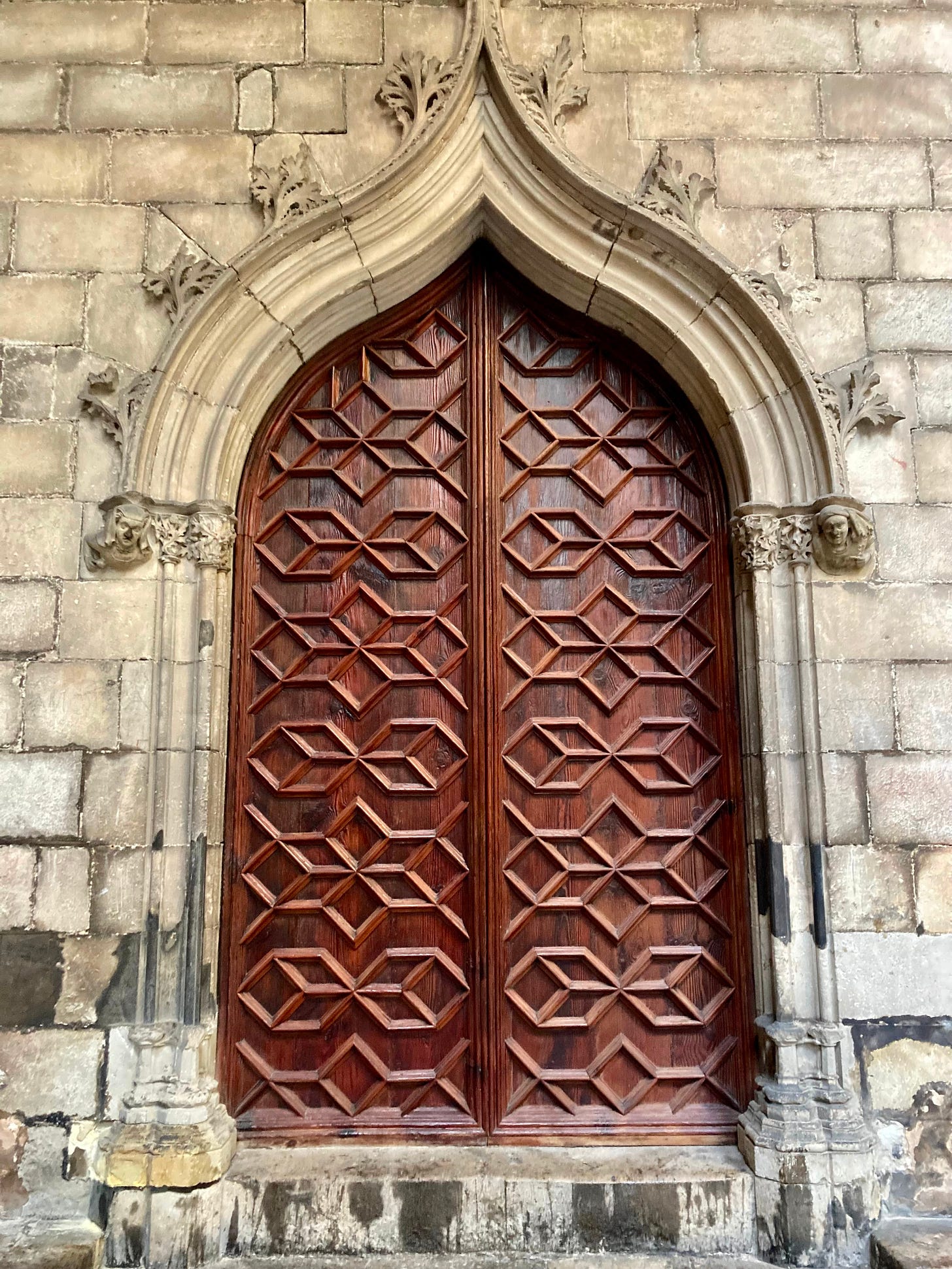 The Surrender: Picture of a bronze medieval door in a stone church wall