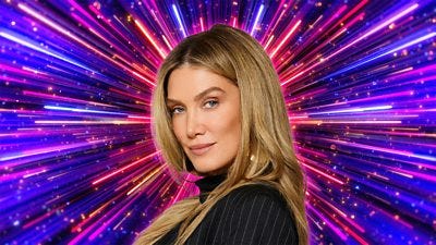 A woman with long blonde hair is pictured side on, looking to camera, set against a background of glittering pink, purple and gold beams of light A woman with long blonde hair is pictured side on, looking to camera, set against a background of glittering pink, purple and gold beams of light