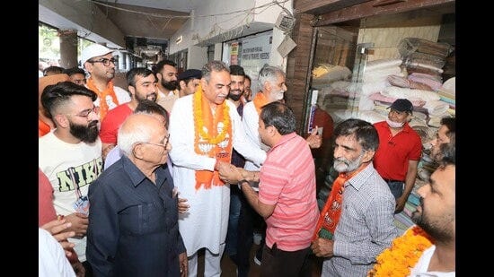 BJP candidate form Chandigarh Sanjay Tandon during his foot march in Chandigarh on Monday. (HT Photo)