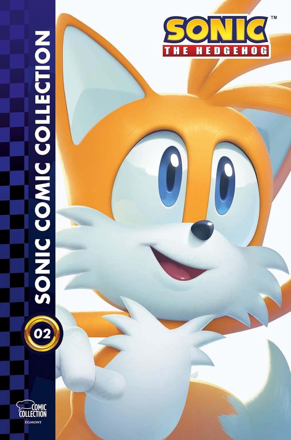 Cover of Sonic the Hedgehog: The IDW Collection Vol. 2. The artwork features a close-up of Tails, Sonic’s fox companion, smiling brightly with his two tails visible. The left side has a blue checkerboard strip with the collection title and a gold ring labeled "02". SEGA’s logo appears in the bottom right corner. Cover of Sonic the Hedgehog: The IDW Collection Vol. 2. The artwork features a close-up of Tails, Sonic’s fox companion, smiling brightly with his two tails visible. The left side has a blue checkerboard strip with the collection title and a gold ring labeled "02". SEGA’s logo appears in the bottom right corner.