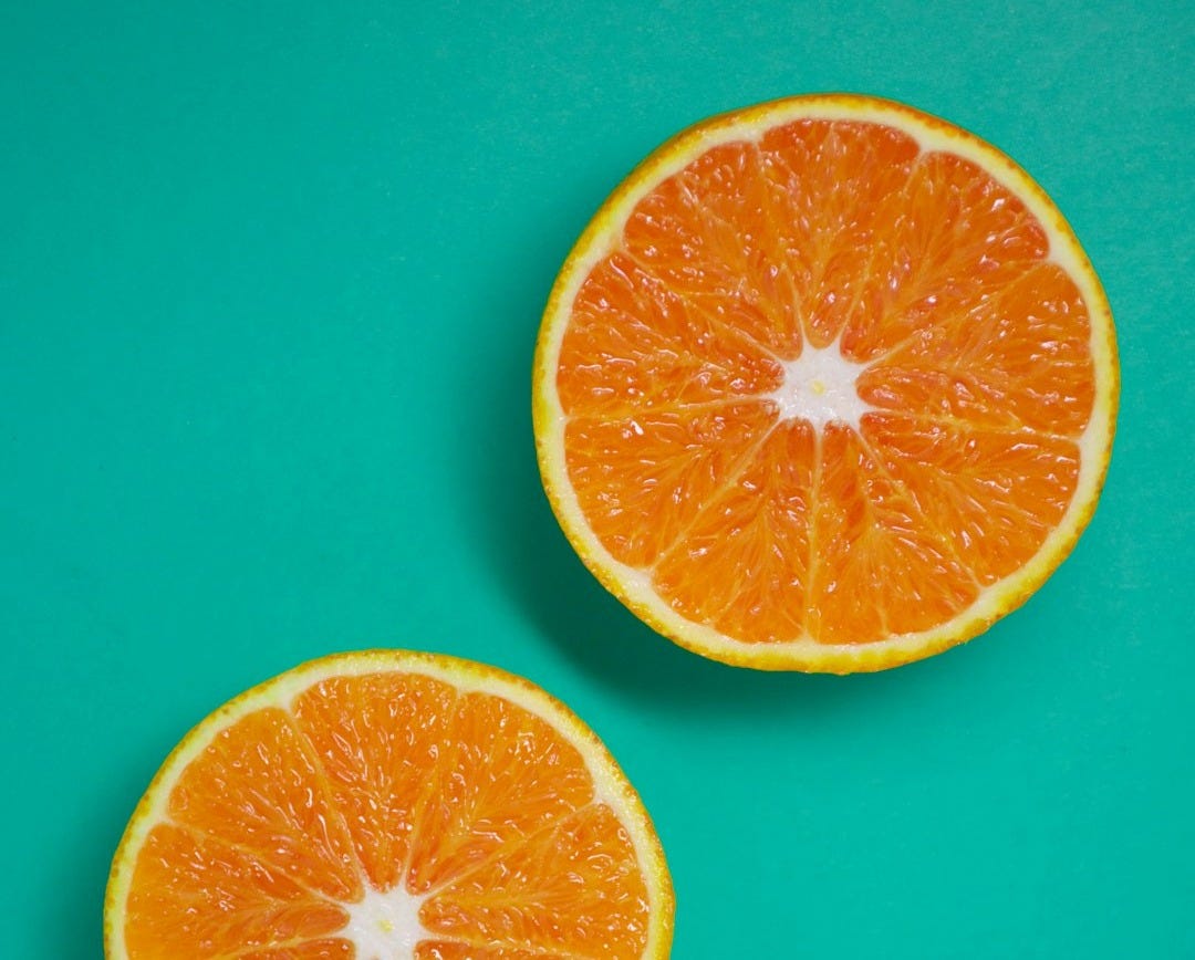 sliced orange fruit on blue surface