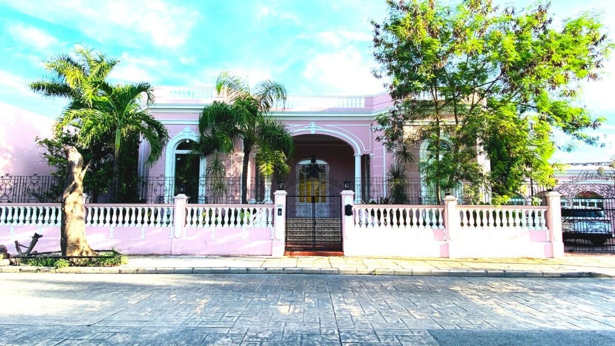Pink colonial house with trees on Calle 59 in Centro Merida Mexico