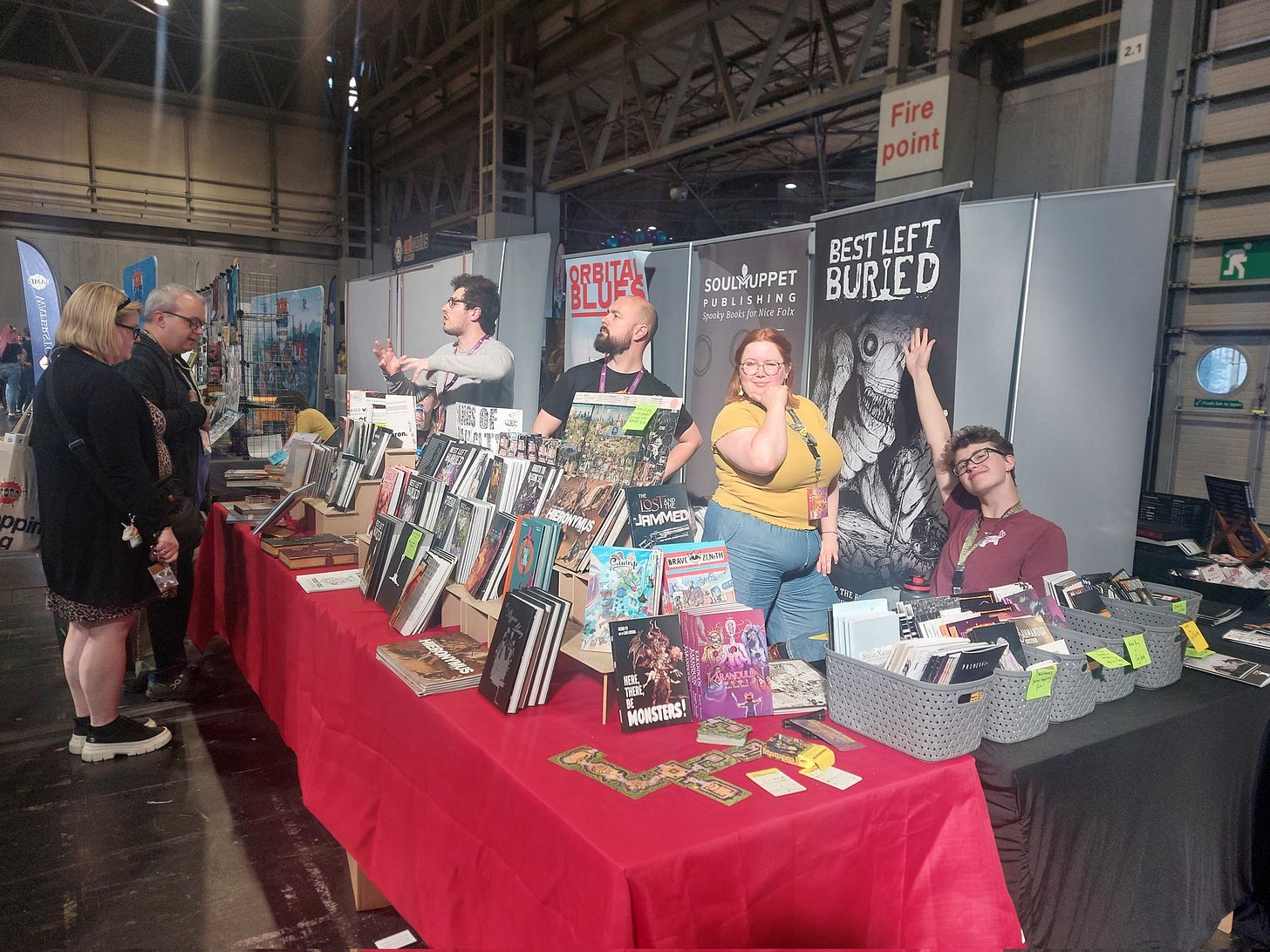 Photo of the soul muppet stand with us all posing behind the stands of games.