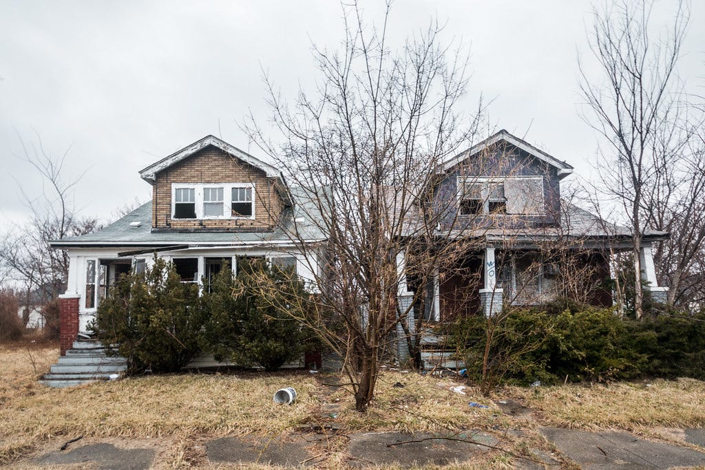 Two rundown homes in Detroit. Two rundown homes in Detroit.