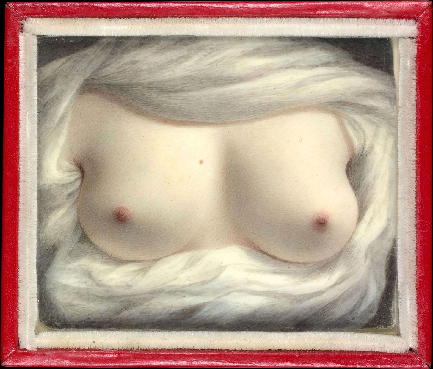 "Beauty Revealed" by Sarah Goodridge: a watercolor-on-ivory miniature depicting a pair of bared female breasts. The central subject is framed by the layered white folds of a chemise or ruffled fabric that fills the perimeter of the small red frame. The skin is rendered with realistic, pale tones and soft light, emphasizing the natural curves and physical spill of the body. The background is a flat, neutral gray-beige. Part of the In the Flesh series at The Subtext Review.
