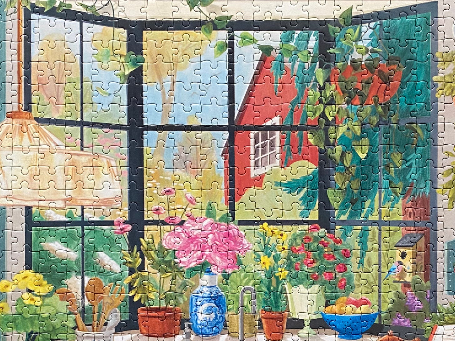 close up of a puzzle showing a large picture window with a nature scene outside