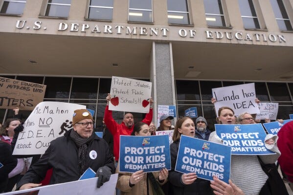 Protestors gather during a demonstration at the headquarters of the Department of Education, Friday, March 14, 2025, in Washington. (AP Photo/Mark Schiefelbein) Protestors gather during a demonstration at the headquarters of the Department of Education, Friday, March 14, 2025, in Washington. (AP Photo/Mark Schiefelbein)