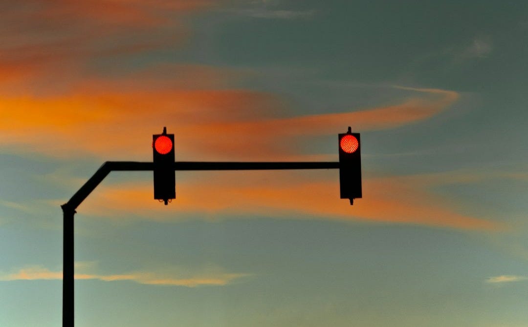 silhouette of person standing on top of building during sunset