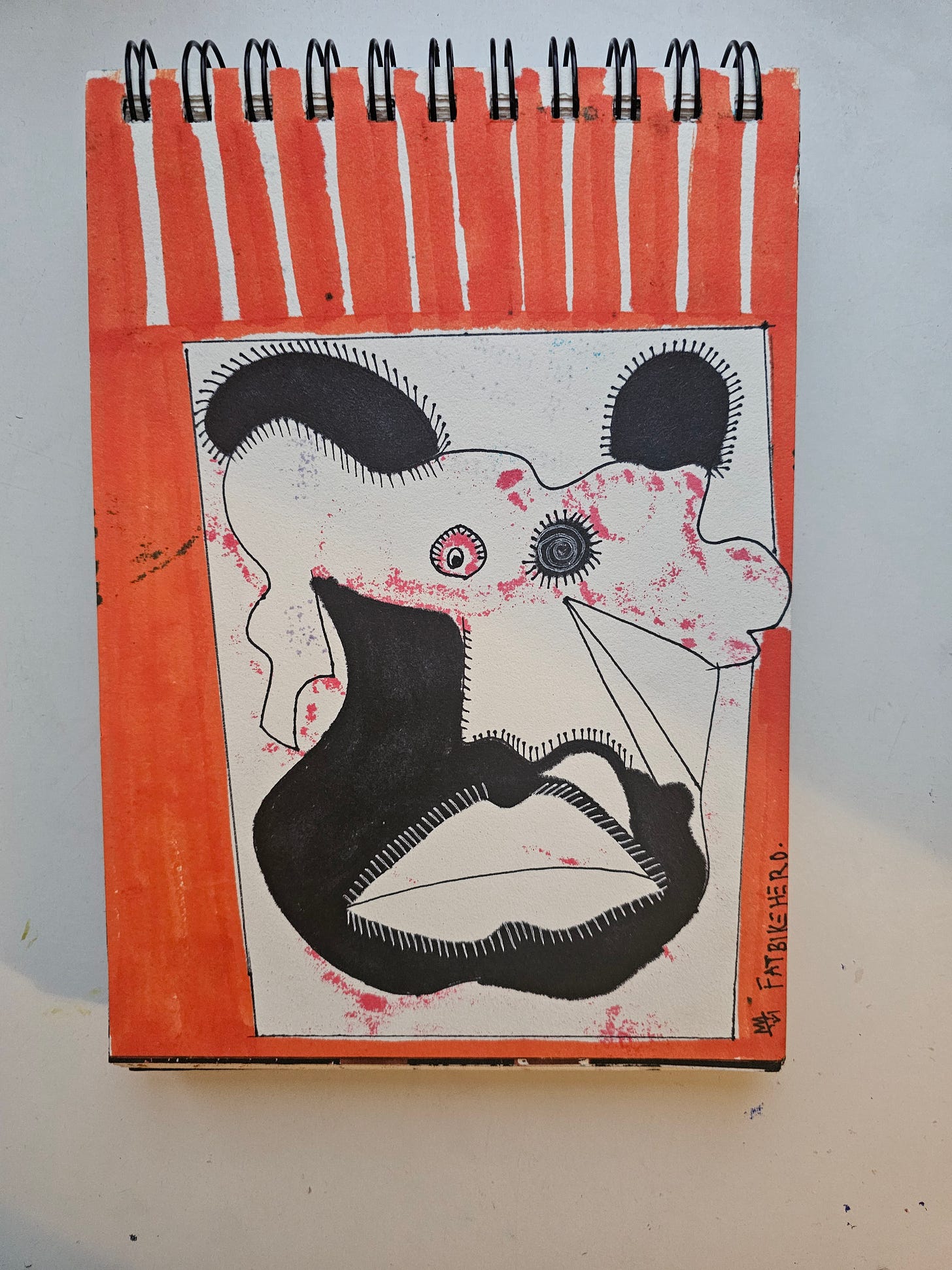 Alt Text: An ink and marker drawing by FatbikeHero titled Elite Arctic Military Rookie. The image features a distorted, abstract face with one wide, stunned eye and one spiraling eye, conveying confusion and naive shock. The figure is framed by vertical orange stripes on a sketchbook page. The style is raw, expressionist, and uses heavy black ink.