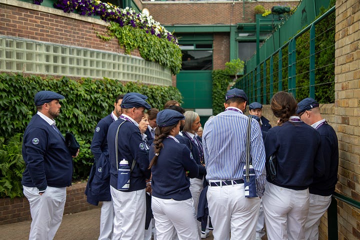 Four scenes from Wimbledon: Ben Shelton serving on an outside court, ball boys and ball girls huddled in Wimbledon uniforms, rain covers pulled across a court showing the Wimbledon crest, and the Royal Box on Centre Court during the Federer ceremony