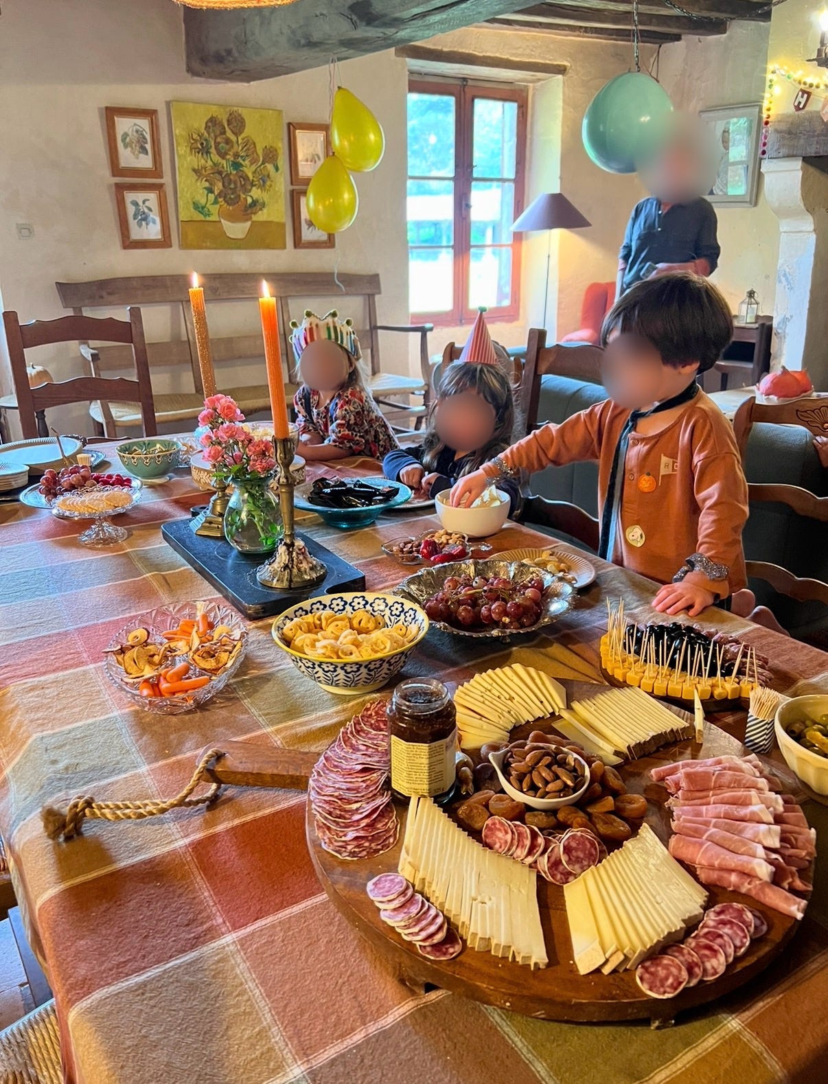 A large spread of party food, charcuterie, and snacks laid out on a table for a children's birthday party. A large spread of party food, charcuterie, and snacks laid out on a table for a children's birthday party.