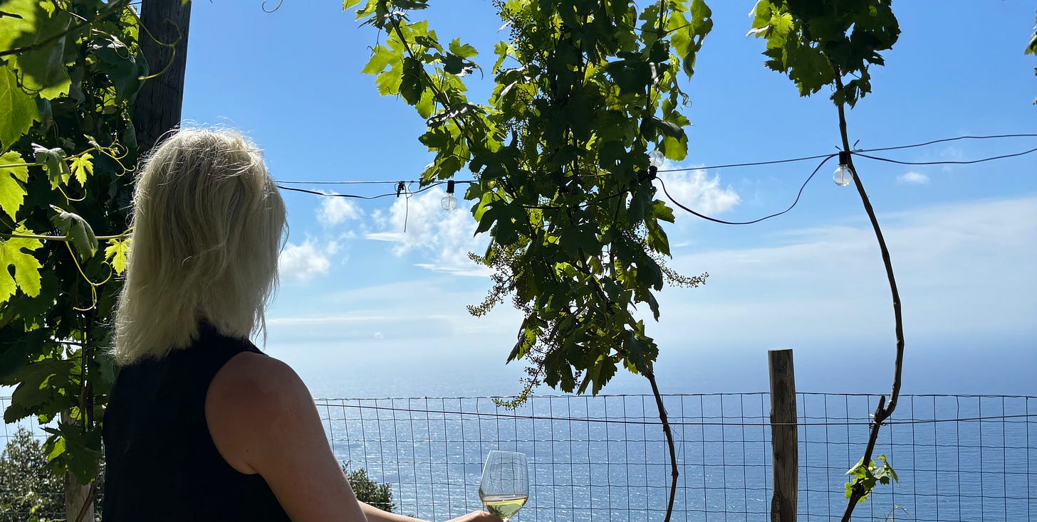Kelly seated and looking out across the sea