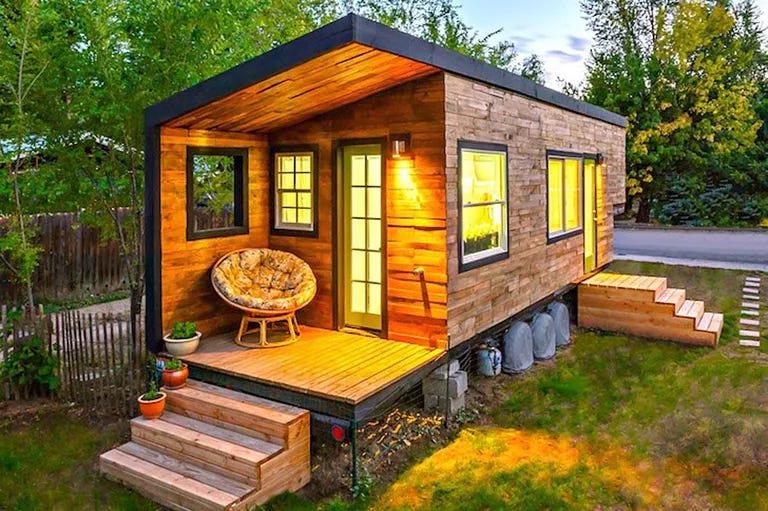 Exterior of tiny house with steps leading up to a front porch