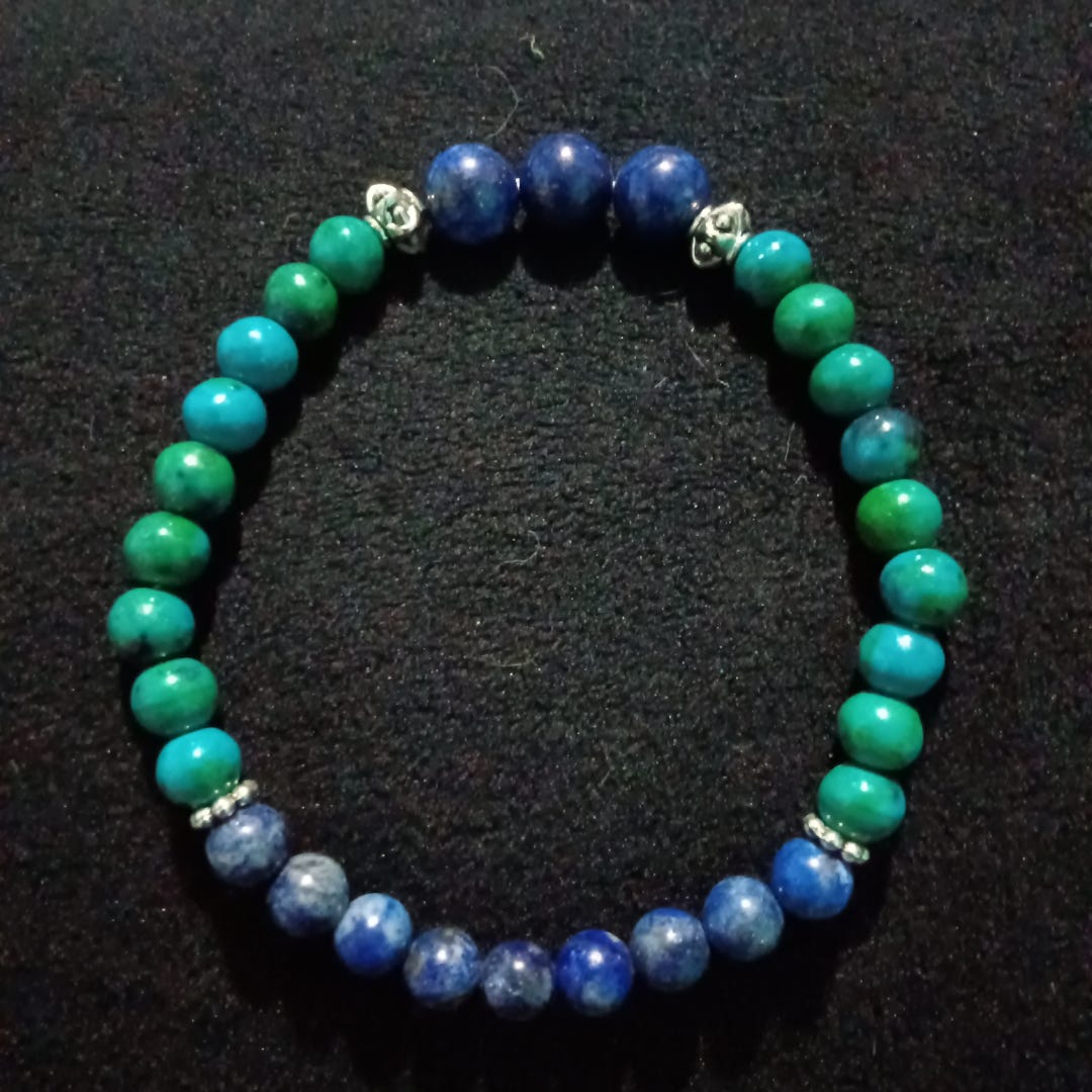 Bracelet with blue and green stones on a black background Bracelet with blue and green stones on a black background