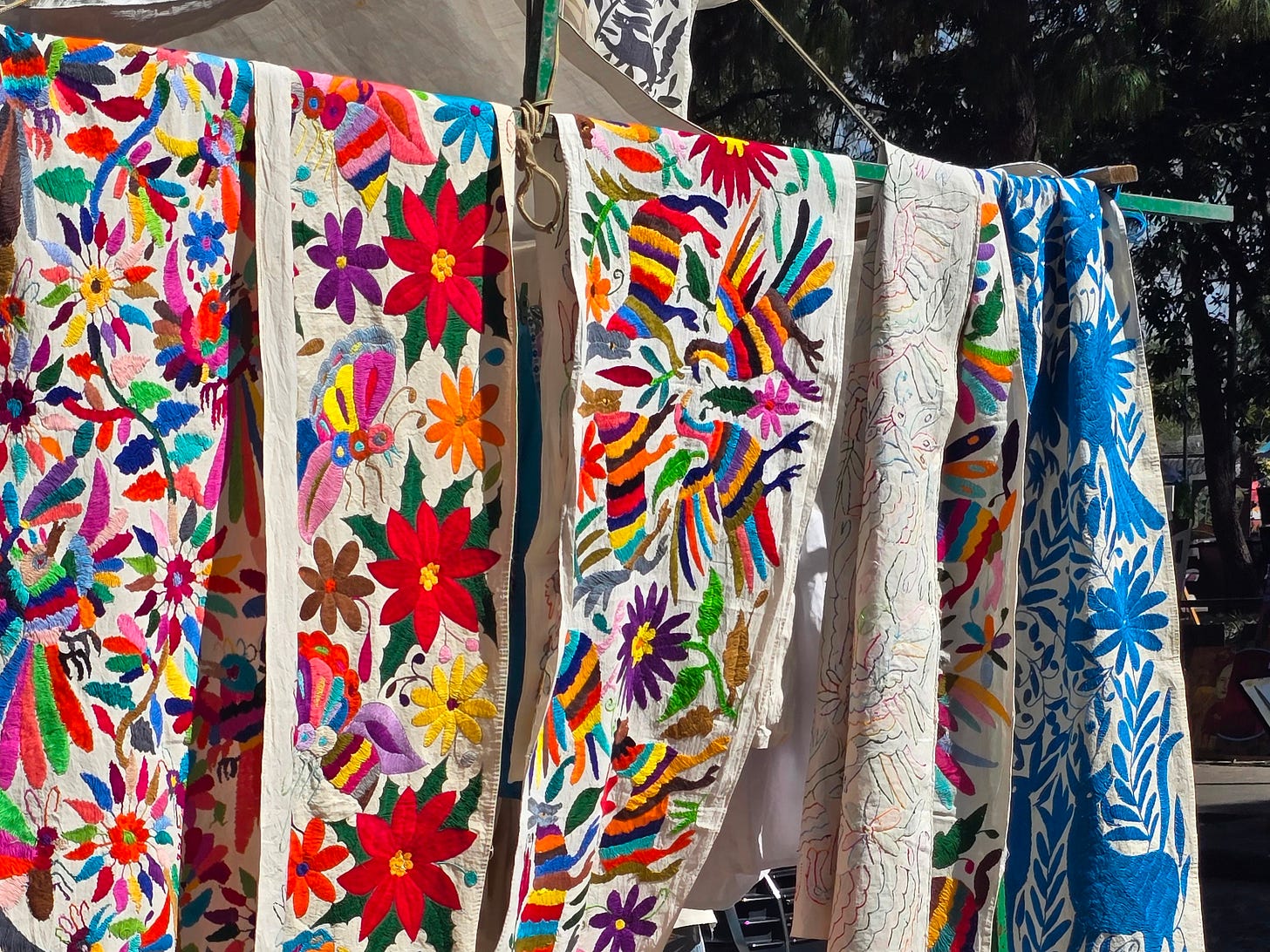 Colorful embroidered table runners for sale.