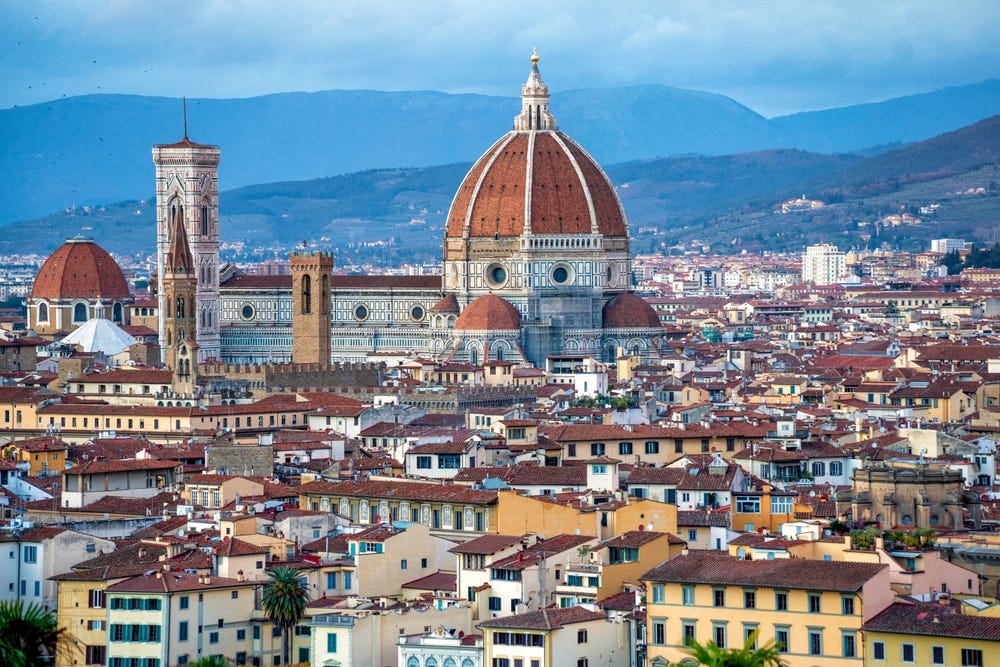 May be an image of bell tower and the Arno River