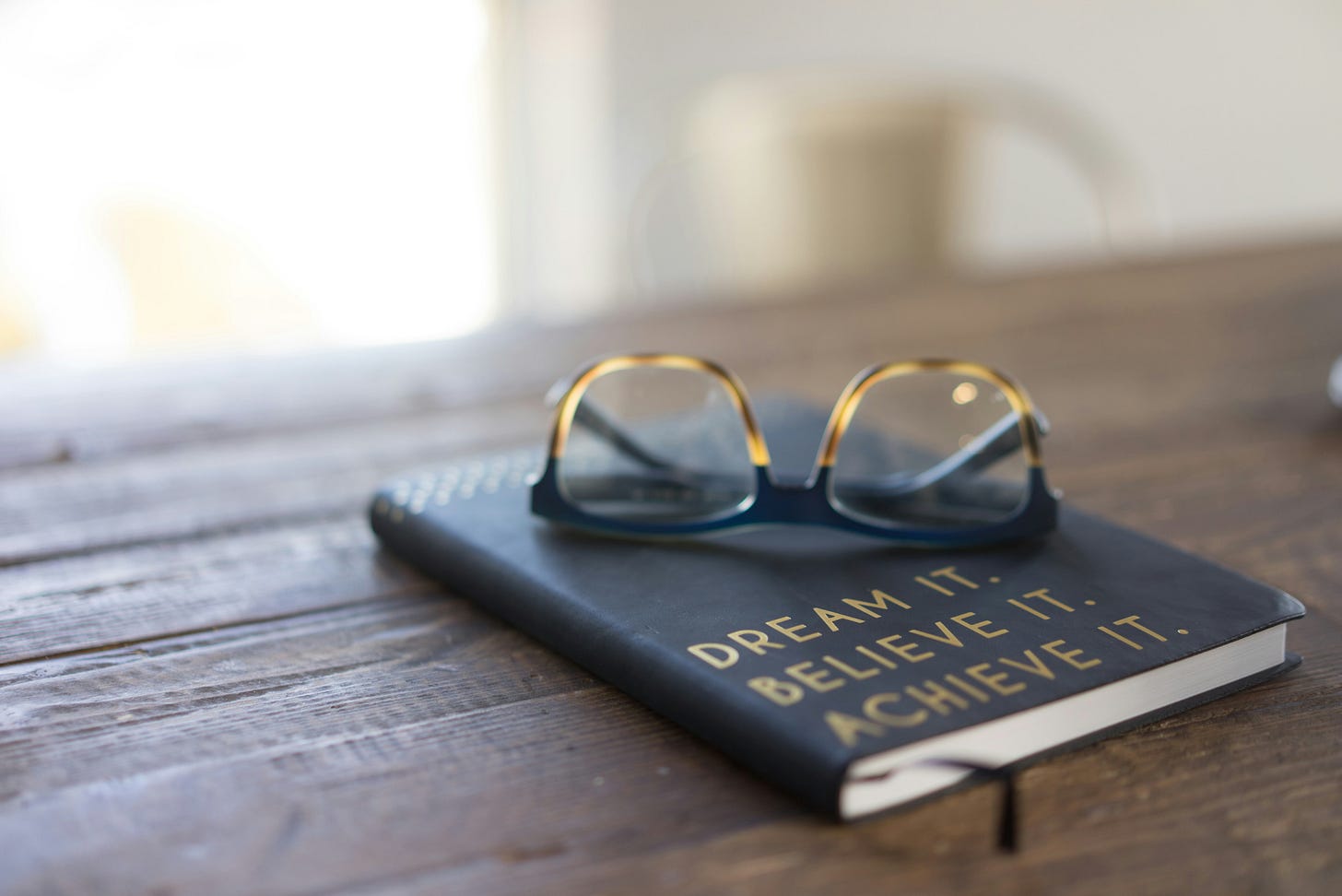 a pair of glasses on top of a notebook