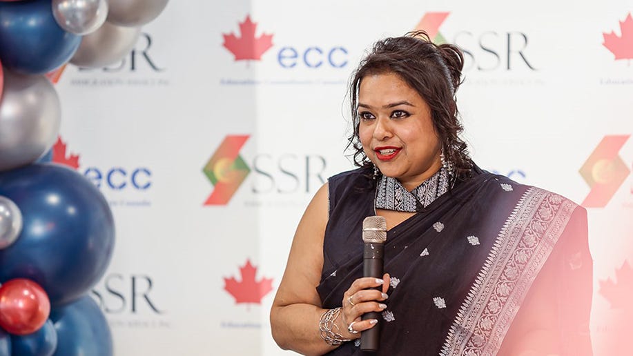 Alumna Sanchari Sen Rai talking on a microphone.