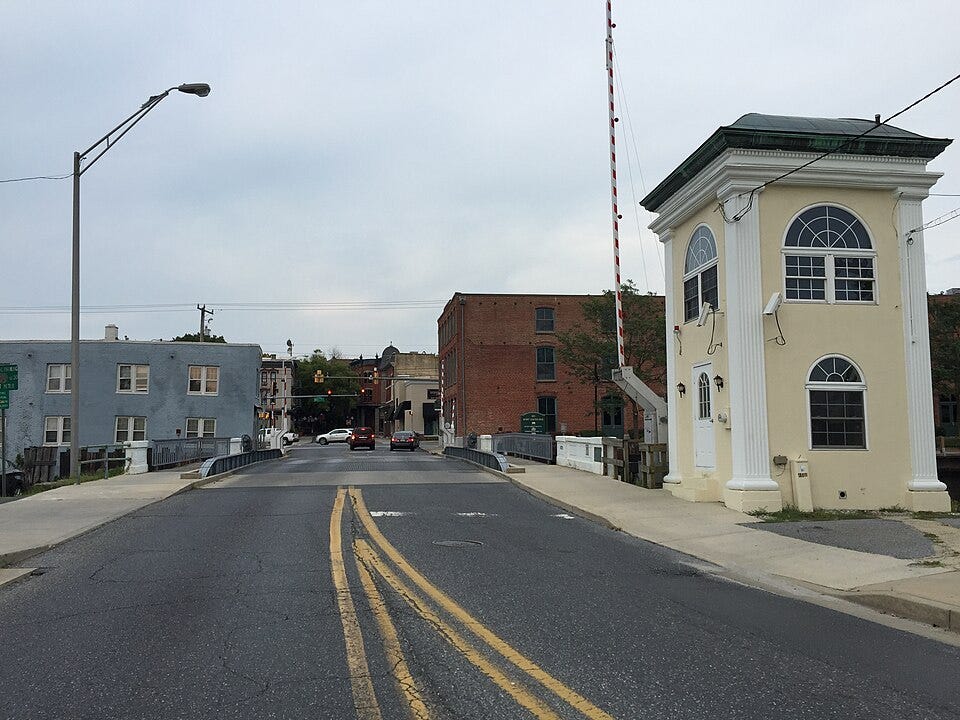 A white building stands beside a street near the bridge over the Wicomico River in Salisbury, MD. A white building stands beside a street near the bridge over the Wicomico River in Salisbury, MD.