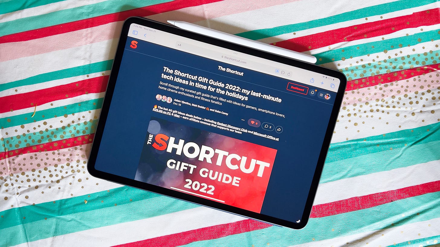 An iPad Pro sits on a festive tablecloth