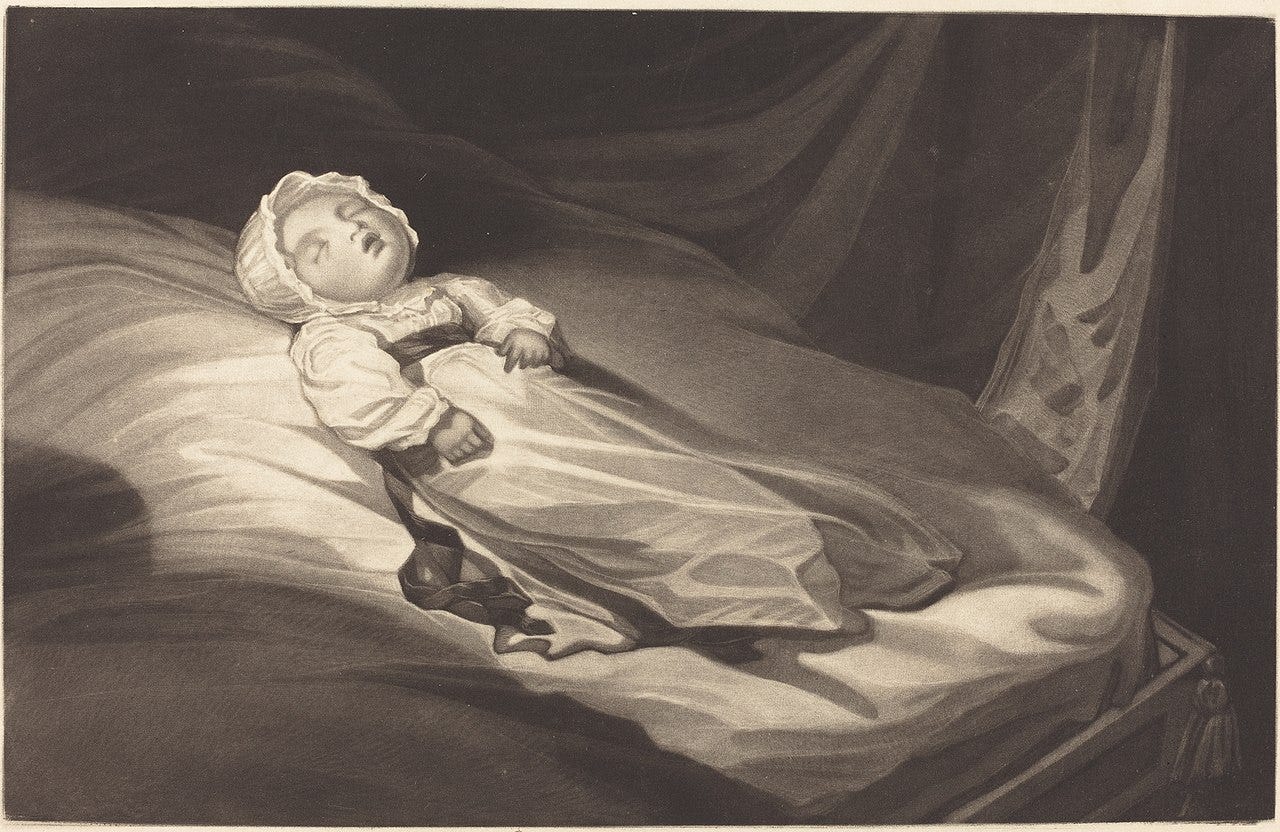 sleeping infant on a bed
