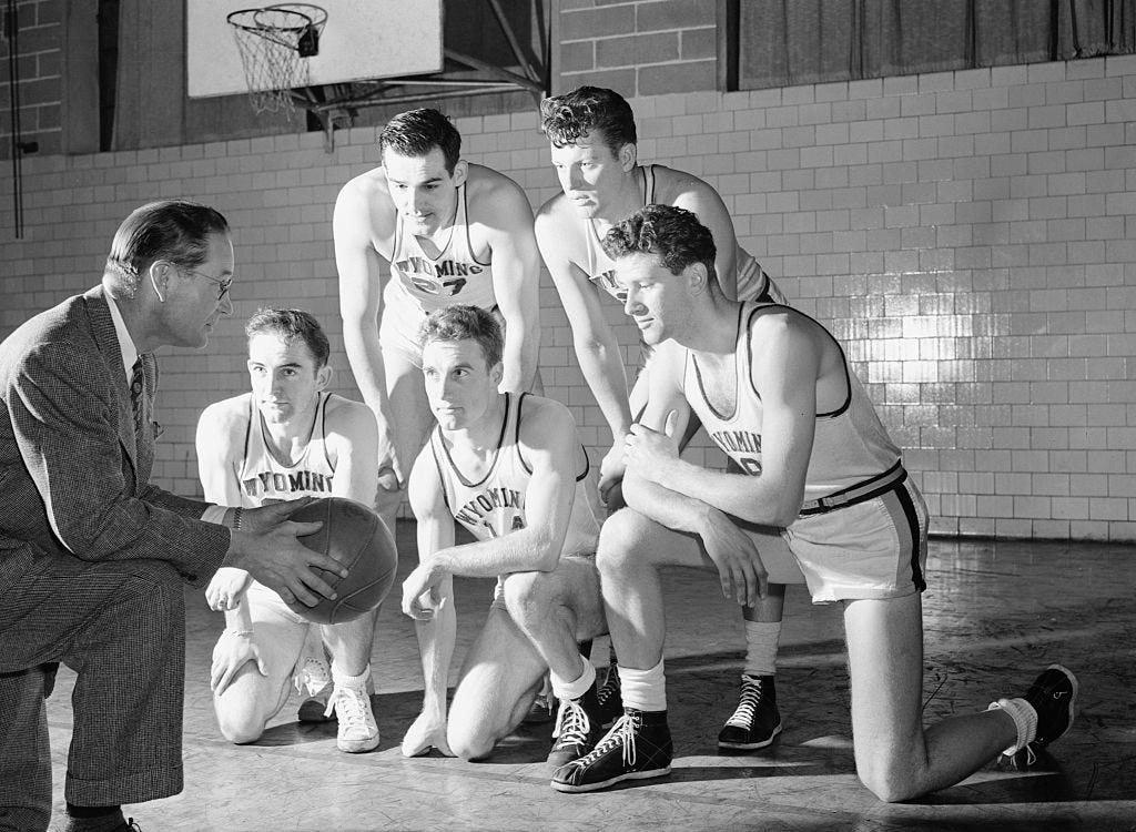 The Wyoming basketball team, left to right: Coach Everett Shelton; James Reese, forward; Milo Komenich, center; Kenny Sailors, forward; James Weir, guard; and Leon Brown, guard.