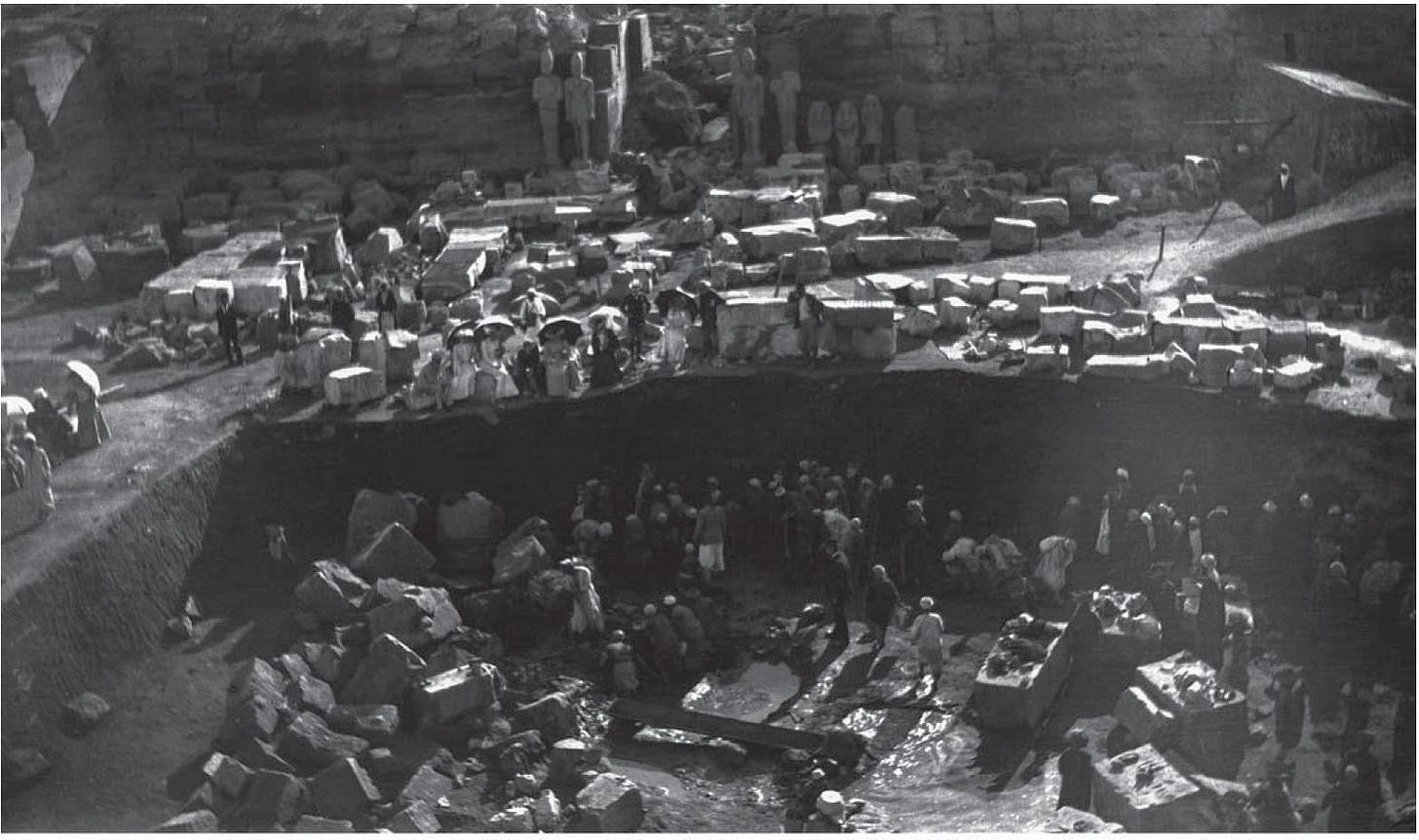 The excavation of the Karnak Cachette, a huge pit containing over 800 stone  statues and 16,000-17,000 bronzes, as it was seen on 21 January 1904.  Notice the seated ladies with parasols watching