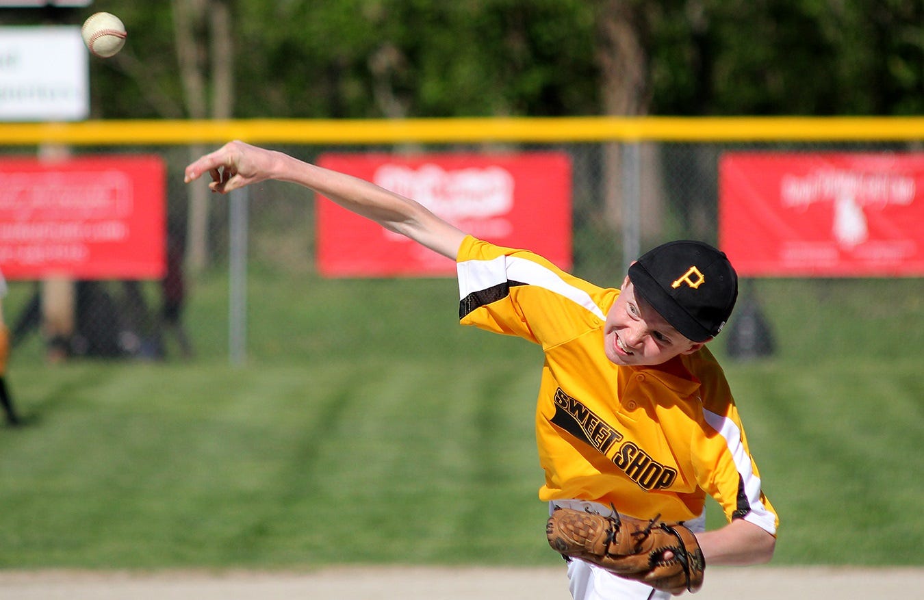Like practically everywhere else in America, youth sports are a major attraction for kids and adults alike. Some argue that it’s all taken far too seriously. But, when the game is underway, only competitive spirit remains. Here, a young baseball pitcher grimaces as he struggles to hurl a good fast ball.