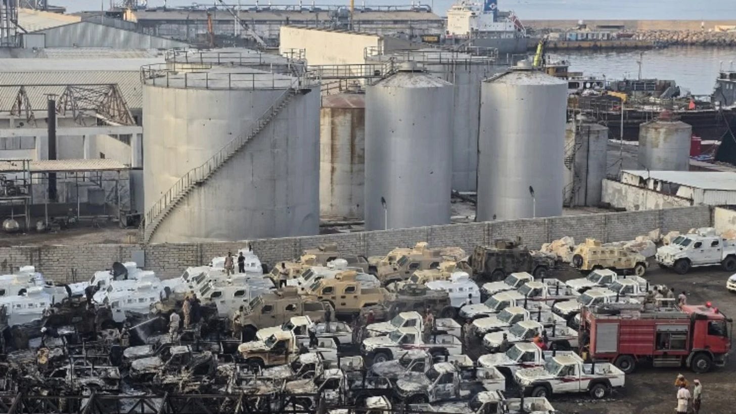 Damaged military vehicles are pictured after an air strike carried out by Saudi forces at the port of Mukalla, southern Yemen, on 30 December 2025 (AFP)