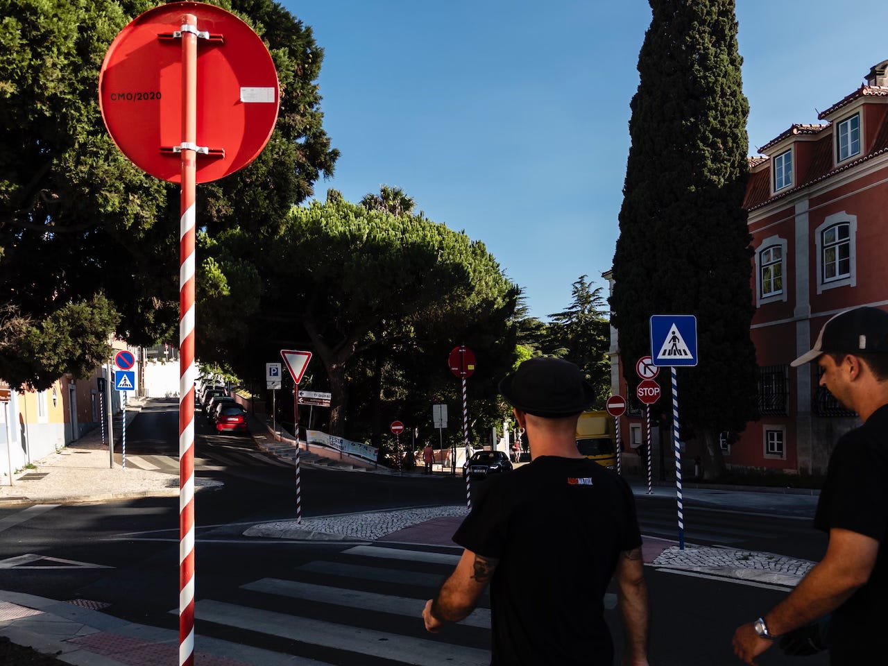 two young men passing by in Oeiras, Portugal